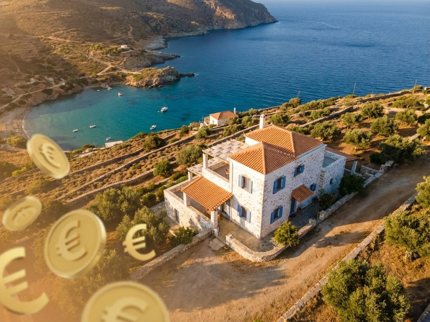 Traditional white Greek villa with terracotta roof on Crete hillside overlooking turquoise Aegean Sea with floating gold coins