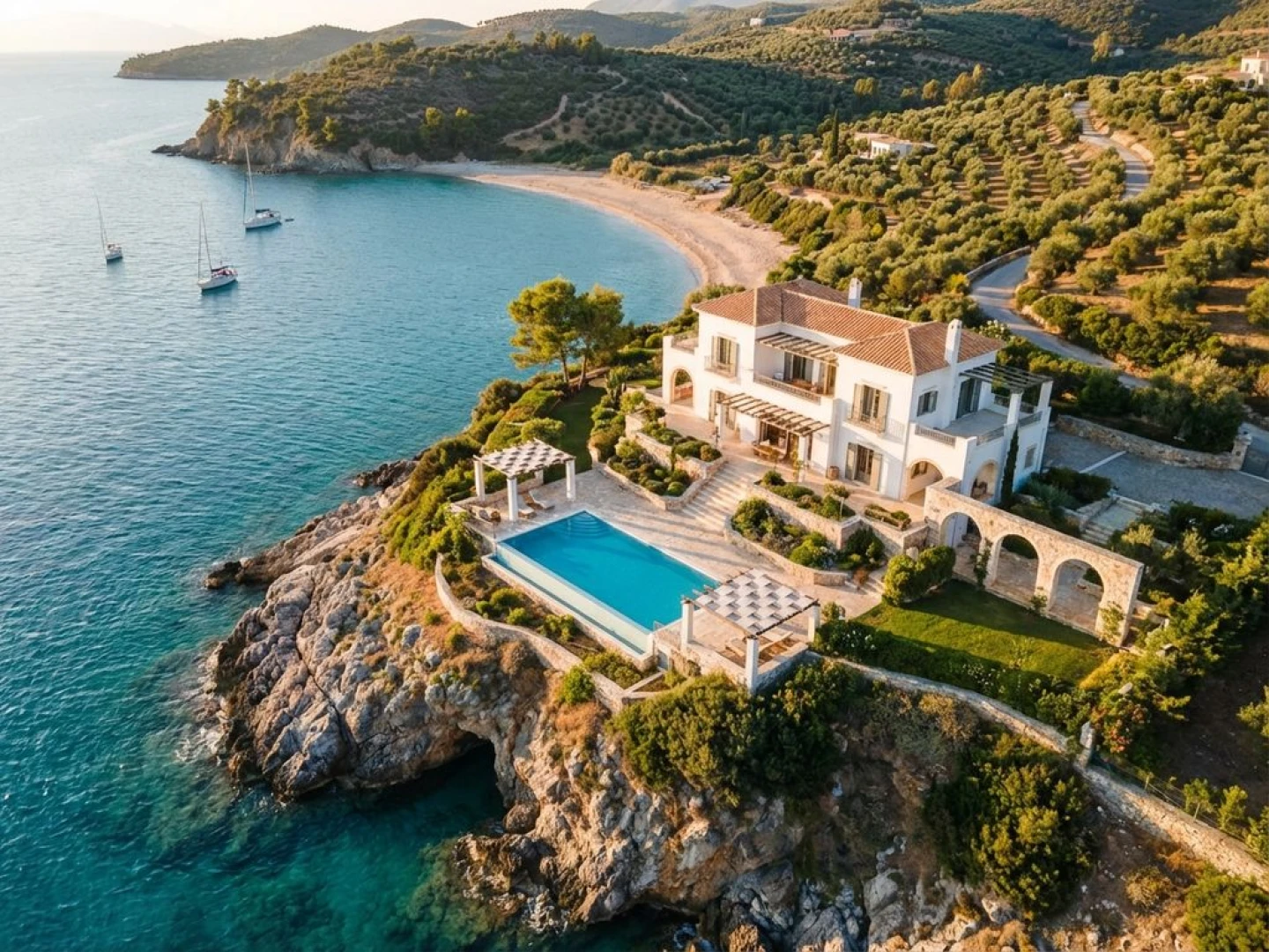 Luxury white villa with infinity pool on cliff overlooking turquoise Mediterranean waters in Peloponnese, Greece